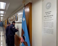 two people removing lettering from a wall