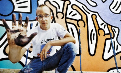 Keith Haring at work on his mural Tuttomondo on the wall of the Church of Sant’Antonio, Pisa, in 1989. 