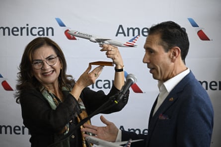 Faría holding the replica aircraft during a press conference with Freig (right).