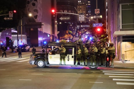 Law enforcement officials on a van on a road in Los Angeles.