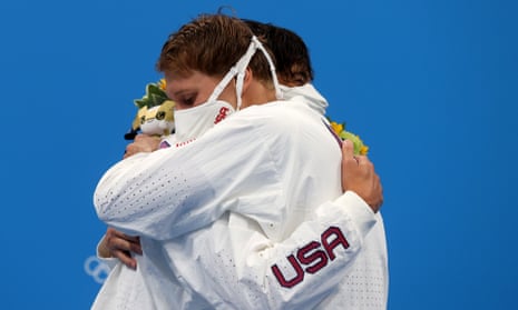 The US swimmers Jay Litherland (left) and Chase Kalisz embrace on the podium – which is in breach of Olympic Covid rules – following the men’s 400m individual medley.