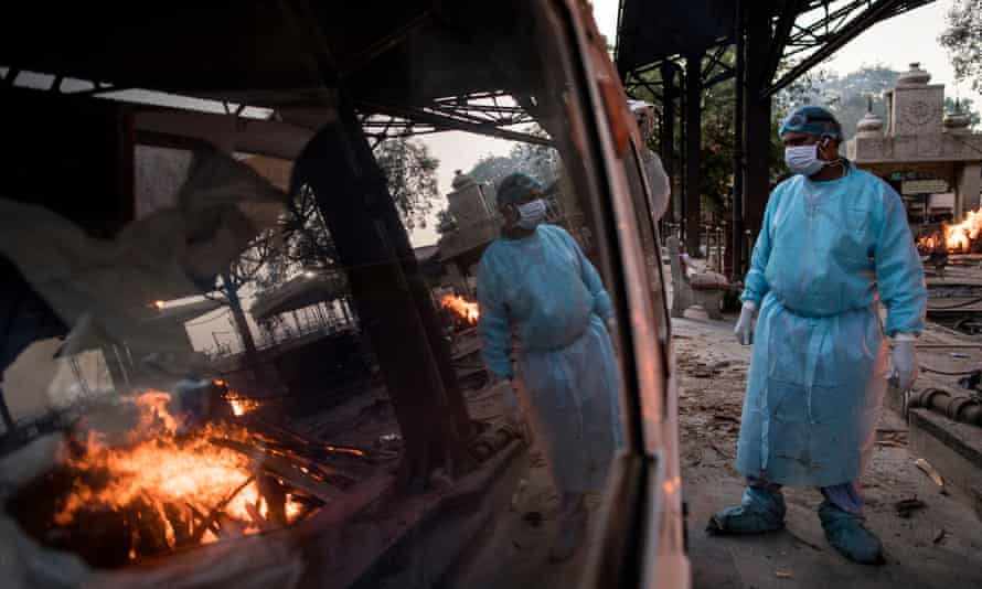 A worker waits to transfer the body of a patient who died of coronavirus at a crematorium in Delhi.