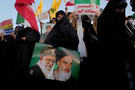 An Iranian woman holds a poster of the late revolutionary founder Ayatollah Khomeini, right, and Supreme Leader Ayatollah Ali Khamenei in an anti-U.S. and anti-Israeli rally at Enqelab-e-Eslami (Islamic Revolution) square in downtown Tehran, Iran, Tuesday, June 24, 2025.