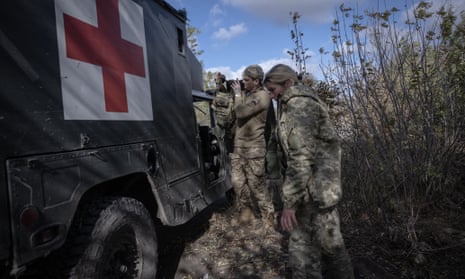 Medics transfer a wounded Ukrainian soldier to  hospital, during the Russia-Ukraine war, in Avidiivka, Ukraine, on Tuesday.