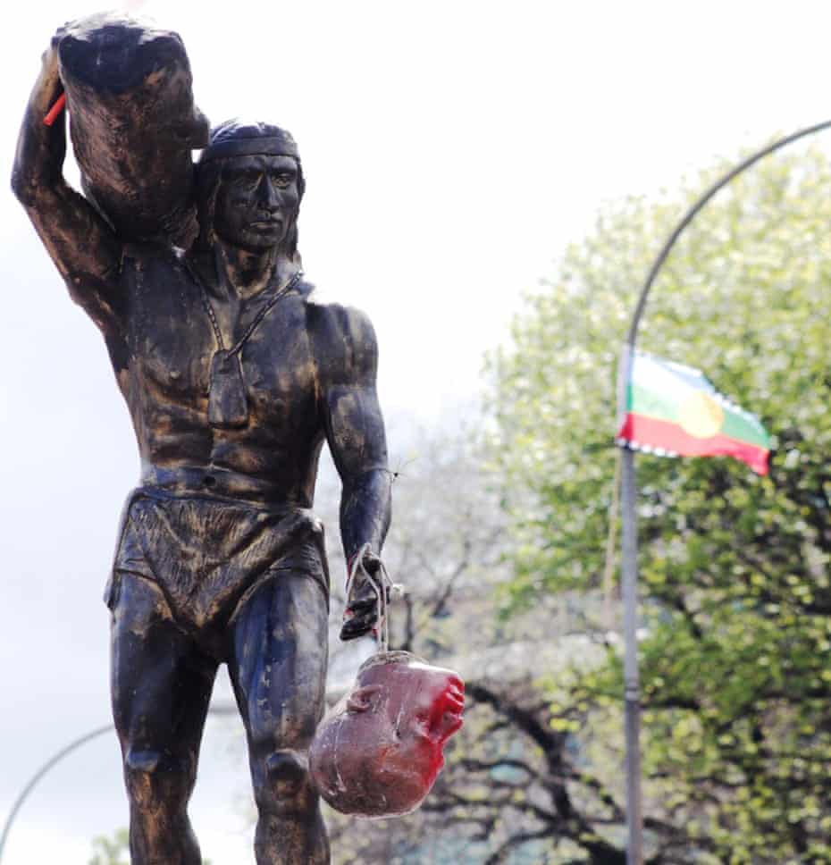 The head of Dagoberto Godoy hangs from a statue of the indigenous Mapuche chieftain Caupolicán after protesters decapitated a statue of the Spanish conquistador in Concepción.