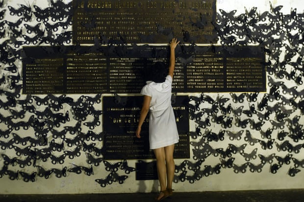 In San Salvador, the woman touches a memorial plate during a protest in commemoration of women murdered in El Salvador