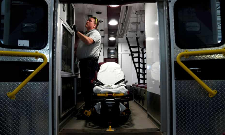 Paramedic Andrew Sherman disinfects an ambulance after transporting a potential coronavirus patient in Shawnee, Oklahoma. The state has not yet implemented a stay-at-home order.