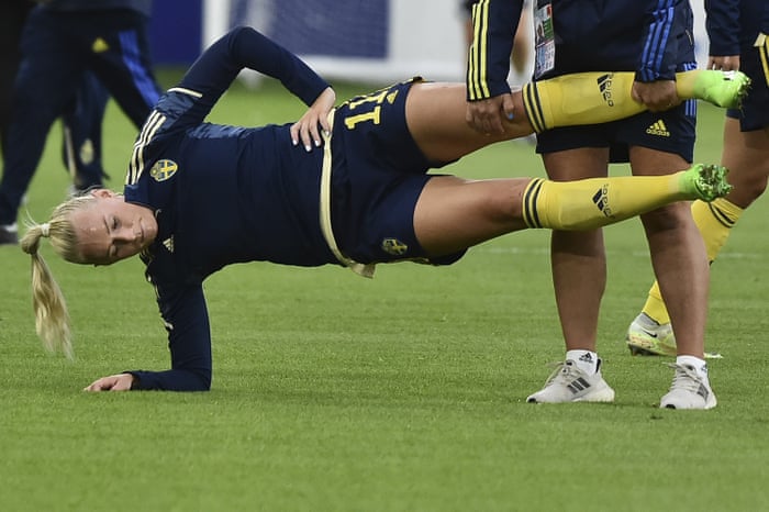 Stina Blackstenius warms up with the help of one of the Swedish staff.