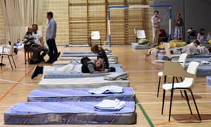 People at a relief centre in a sports hall in Manacor, Mallorca