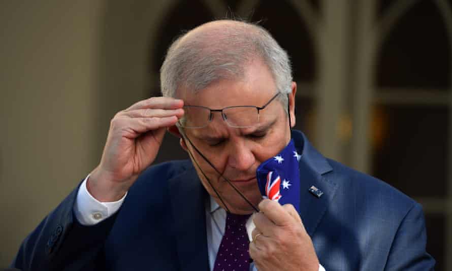 Australian Prime Minister Scott Morrison removes his face mask as he arrives ahead of a press conference at Kirribilli House in Sydney, New South Wales, Australia, 15 July 2021.