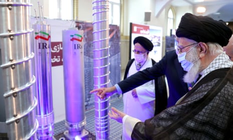 Ayatollah Ali Khamenei points to a nuclear display model