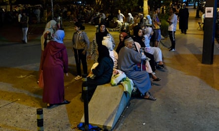 People gather outside seeking safety in Rabat