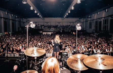 A view from the back of the stage with Hobert performing in front of a packed crowd