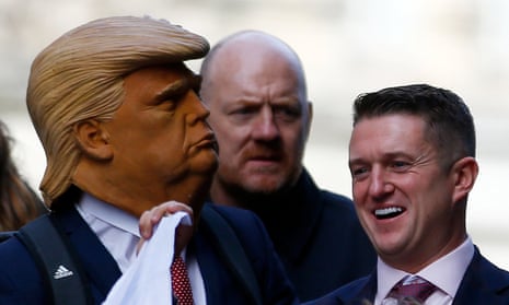Far right activist Stephen Yaxley-Lennon, who goes by the name Tommy Robinson, stands next to a man in a Donald Trump mask