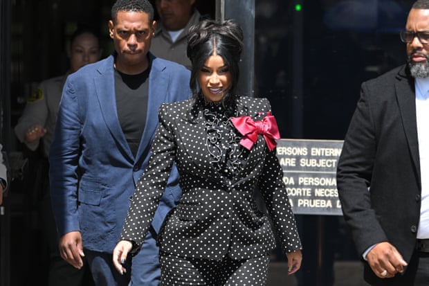 Cardi B in a polka-dot suit with a pink bow brooch