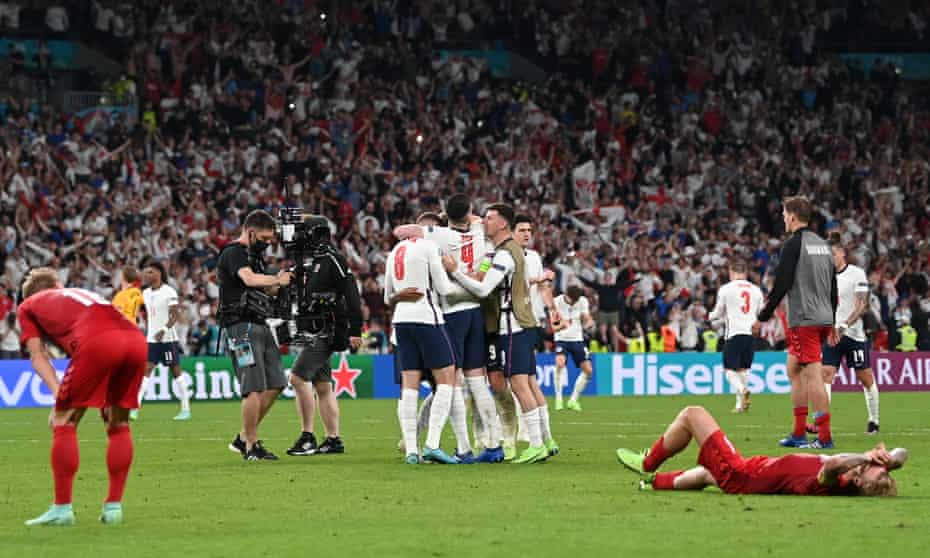 Daniel Wass (left) and Simon Kjaer (right) of Denmark slump onto the pitch at the final whistle.