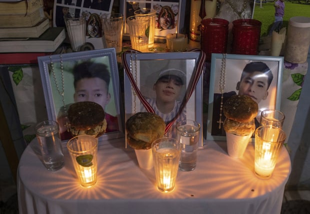 Framed photos of Jair, Misael and Yovani Valencia are displayed on an altar during a wake in San Marcos Atexquilapan, Veracruz.