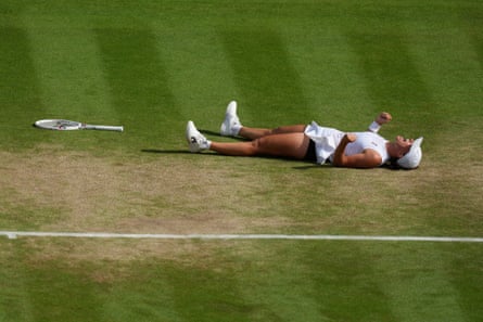 Iga Swiatek lies connected nan writer astatine Wimbledon pinch her fists clenched successful ceremony