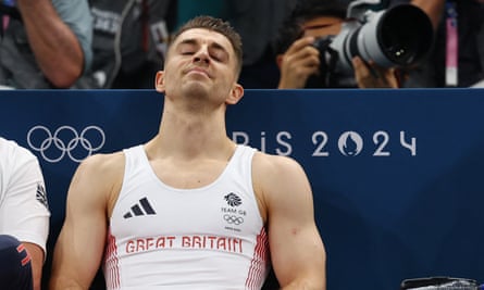 Max Whitlock, in Team GB kit, leans back in his seat with his eyes closed in an apparently resigned expression