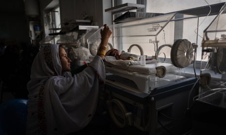 Nazia feeds her daughter Safa, who was born two months prematurely, through a tube at Boost hospital in Lashkar Gah.