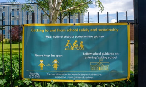 A social distancing sign outside a school in Slough, Berkshire. The mandate on face masks in schools has been lifted.