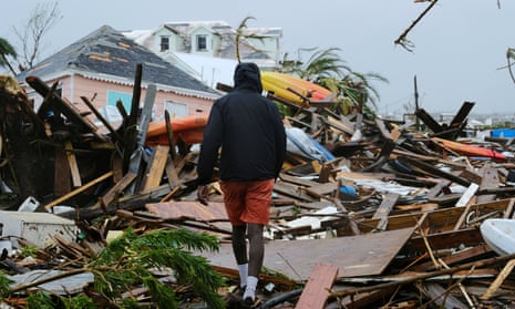 A man walks through the rubble in the aftermath of Hurricane Dorian on the Great Abaco island town of Marsh Harbour, Bahamas, 2 September 2019.