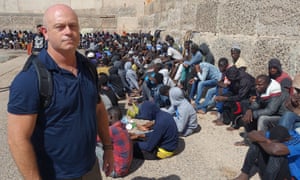 Ross Kemp with migrants back in port