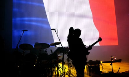 New Order … Backed by the Tricolour at Brixton Academy.