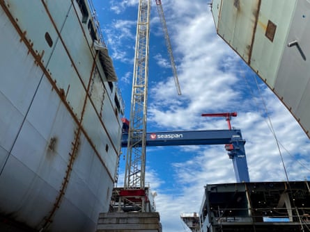 crane beside ship being constructed, as a beam says ‘seaspan’ in background