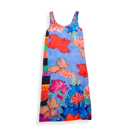 A sleeveless, wide strapped midi slip dress by Folk. Its base is light blue with large abstract tulips in red orange pink and blue.