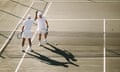 Men playing tennis on a sunny day