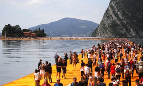 People walk on the monumental installation entitled ‘the Floating Piers’ created by artist Christo Vladimirov Javacheff on Lake Iseo in northern Italy.