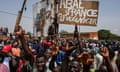 Protesters in Niger hold a placard that reads ‘Abae France Vive le Niger’