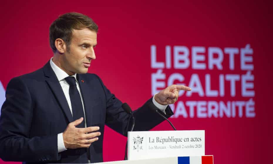 Emmanuel Macron gives a speech in front of the words ‘Liberté, égalité, fraternité’