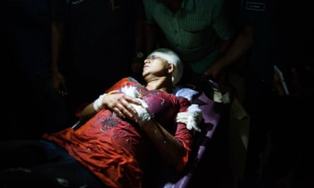 Avijit Roy’s wife, Rafida Ahmed Banna, is carried on a stretcher after being seriously injured by unidentified assailants. Roy founded a blog site which champions liberal secular writing in the Muslim majority nation.