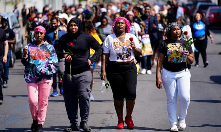 People march to the scene of a shooting at a supermarket in Buffalo, New York, on Sunday.