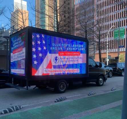 a truck outside says 'blue state lawfare and anti-energy laws are threatening america's pro consumer energy dominance'