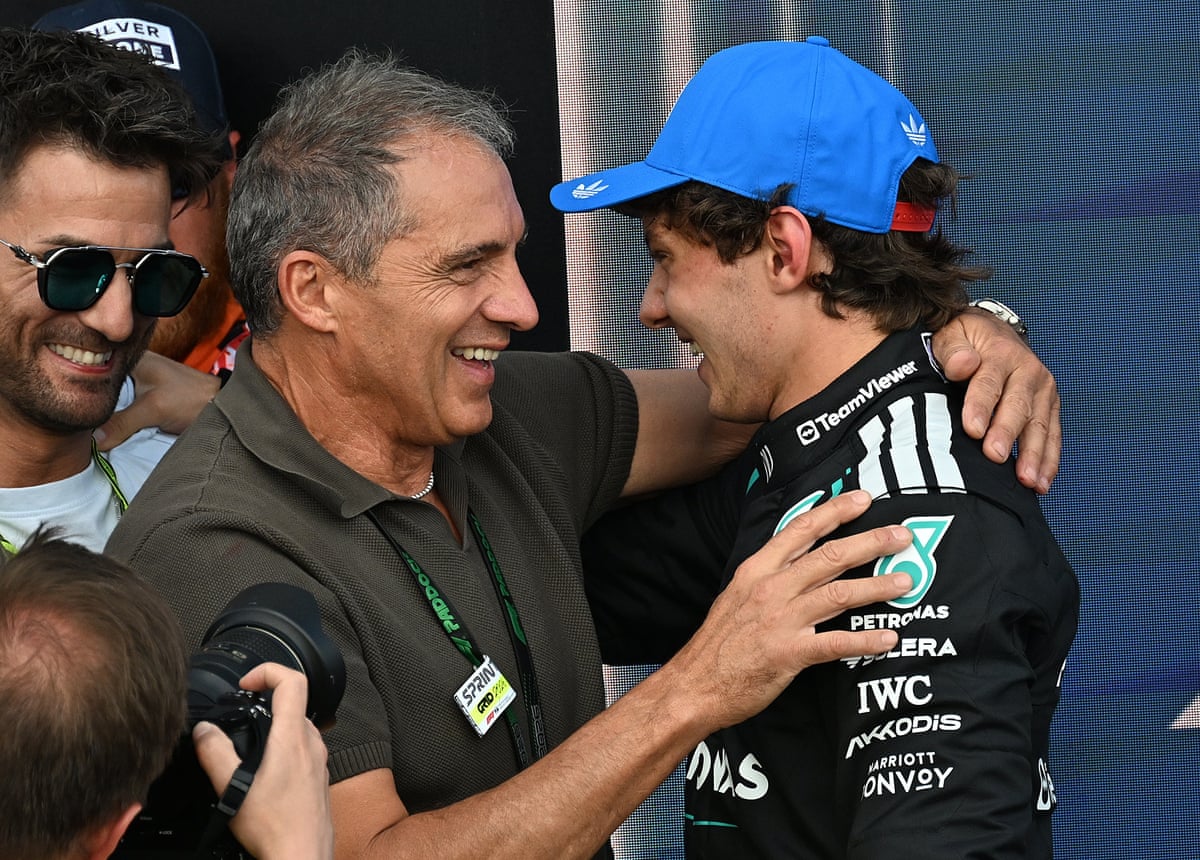Driver Andrea Kimi Antonelli hugs his father Marco, both smiling warmly