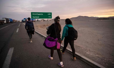 Venezuelan migrants Reinaldo, left, 26, Anyier, 40, and her daughter Danyierly, 14, cross the highlands on the border between Bolivia and Chile on foot.