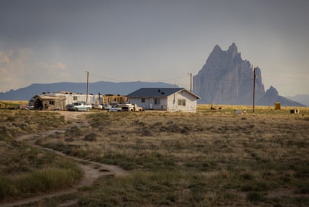 Shiprock stands behind a house on the reservation. The Bens were struck by the absence of fresh, local and traditional baby foods available near the Navajo Nation.