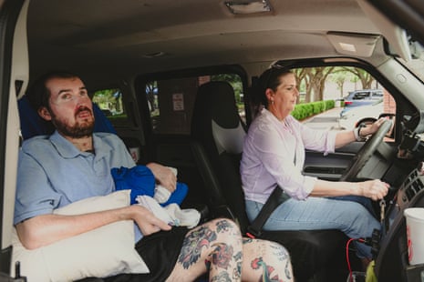 A woman driving, her son in the passenger seat