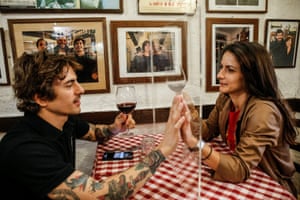 Valerio Calderoni and his wife, Martina, help to test a possible plexiglass separator at Il Ciak’ in Rome
