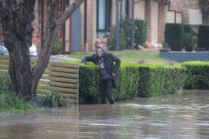 A resident walks along flooded McGrath Street in McGrath Hill, near Windsor, north-west of Sydney.