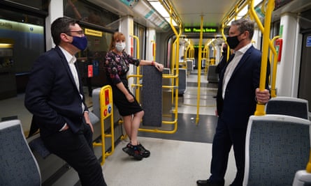 Keir Starmer with Andy Burnham and Angela Rayner on a Metrolink tram, during a visit to Manchester in April.