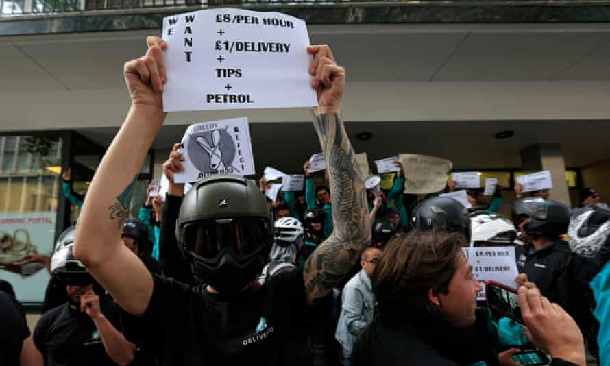Deliveroo riders protesting over pay outside the company HQ in London.