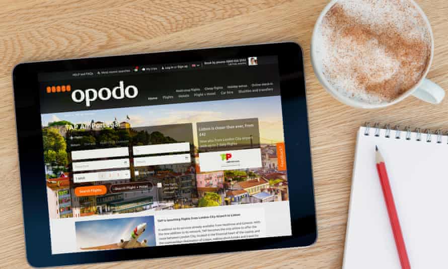 The Opodo website on a tablet computer lying next to a cup of coffee on a table