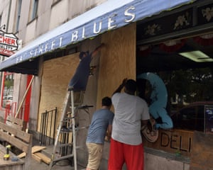 Workers board the windows of the Bay Street Blues today in preparation of the potential arrival of Hurricane Dorian
