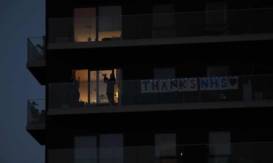 Applause for the NHS from balconies in Stratford, east London.
