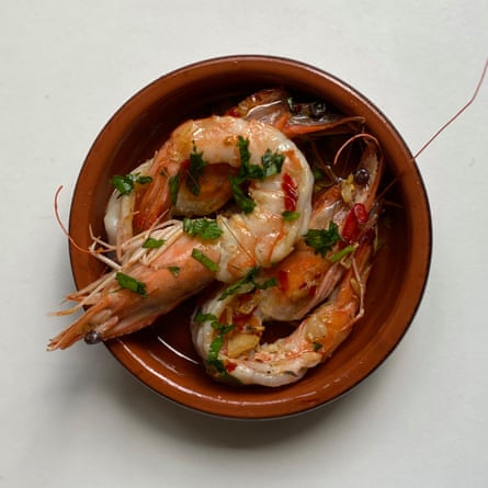 Jose Pizarro’s garlic prawns: remove the shells but leaves the heads and tails on.