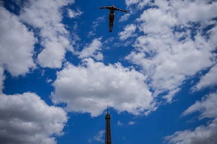 A diver in action during practice as the Eiffel Tower is seen in the background